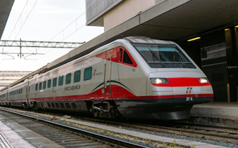 Trenitalia Frecciabianca train at an Italian station platform.