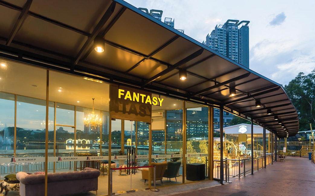 Entrance to Fantasy Hall at 99 Wonderland Park, Kuala Lumpur, with city skyline in background.