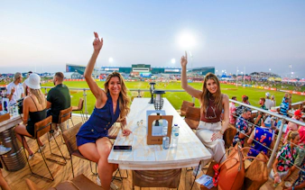 Spectators enjoying the Emirates Dubai 7s from the Sunroom Hospitality area.