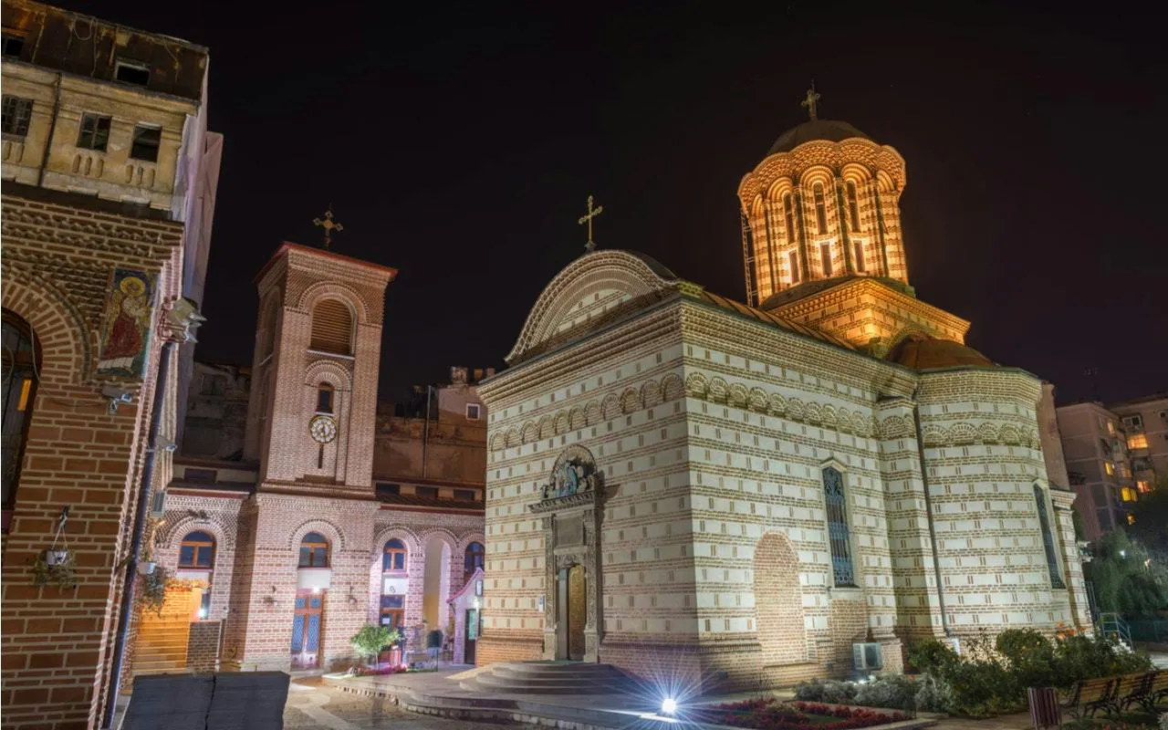 Stavropoleos Monastery illuminated at night, part of the Haunted Bucharest self-guided tour.