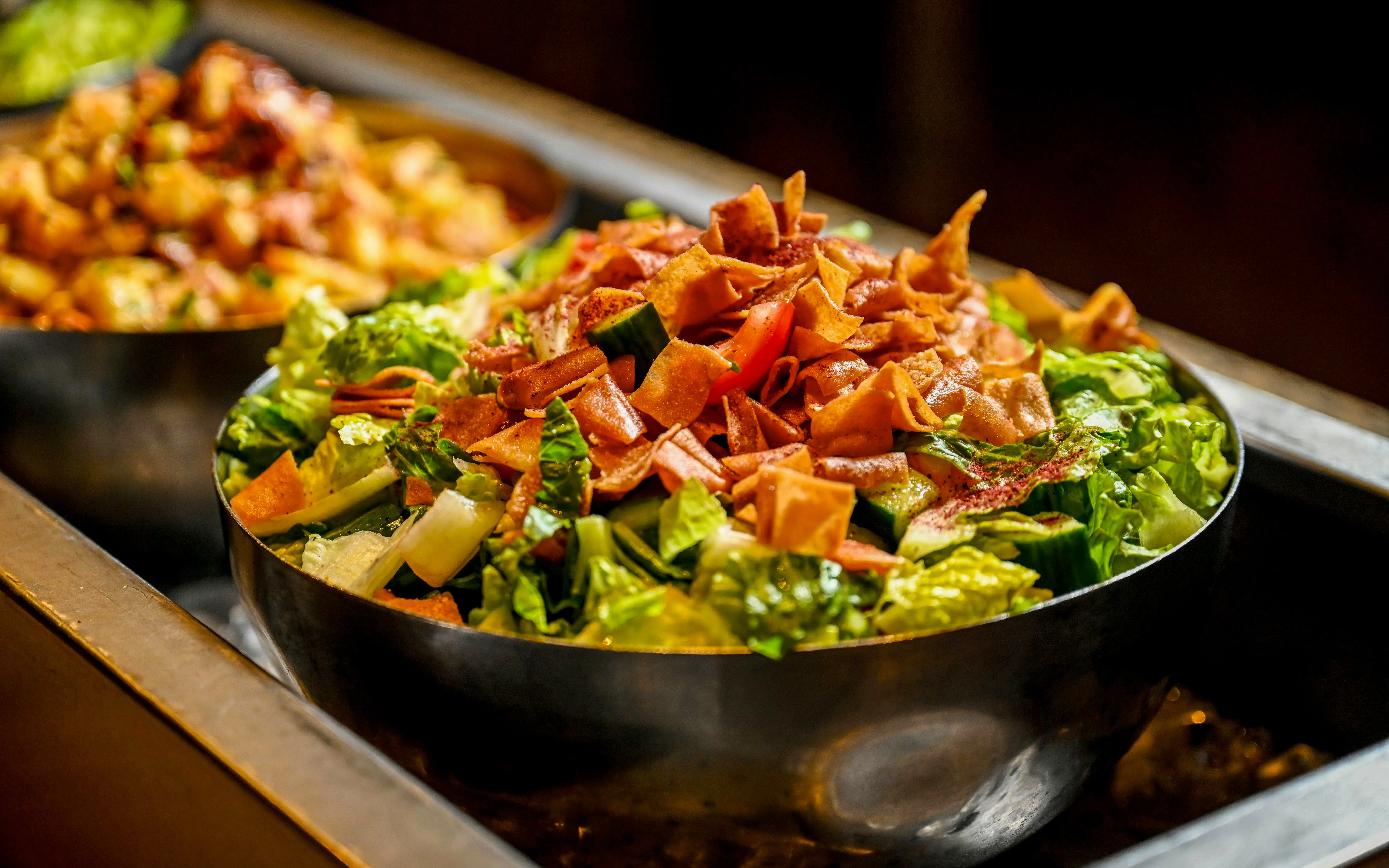 Salad with crispy pita and vegetables served during desert safari meal.