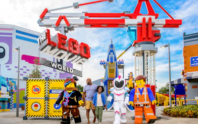 LEGO Movie World entrance with characters and visitors at a theme park in Los Angeles.