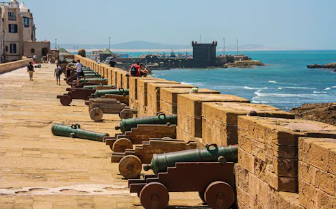 Essaouira coastal ramparts with historic cannons overlooking the Atlantic Ocean.
