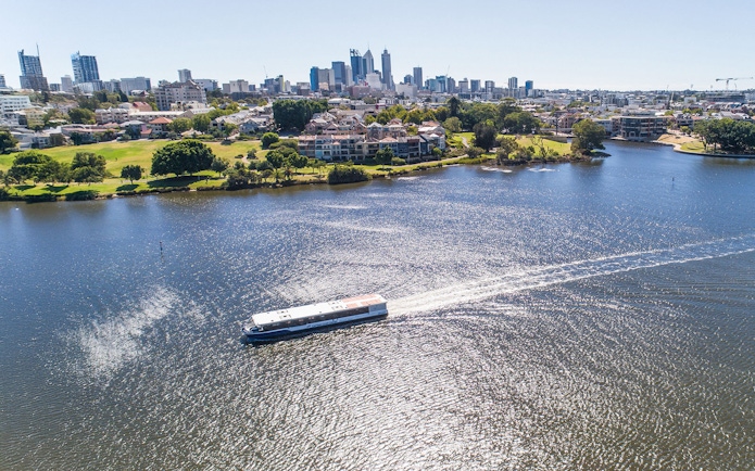 Cruise boat on Swan River with Perth skyline in the background.