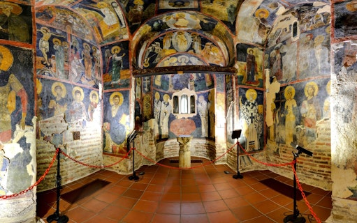 Interior frescoes of Rila Monastery chapel, Bulgaria, depicting religious figures and scenes.