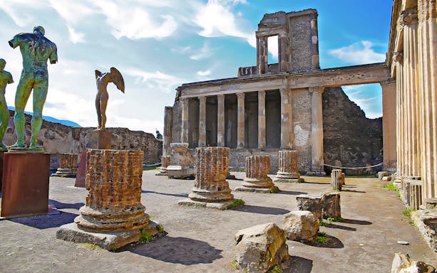 Ancient ruins and statues at Scavi di Pompei, Italy, with columns and historical architecture.