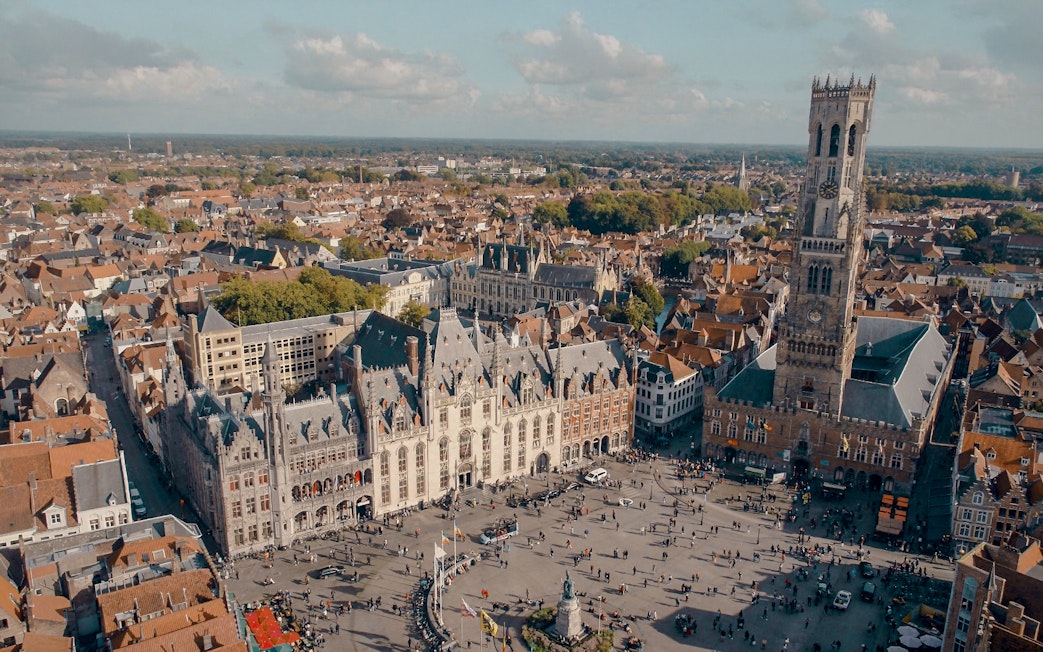 Aerial view of Historium Bruges and Belfry tower in Bruges, Belgium.