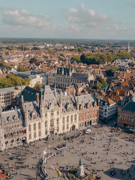 Aerial view of Historium Bruges and Belfry tower in Bruges, Belgium.