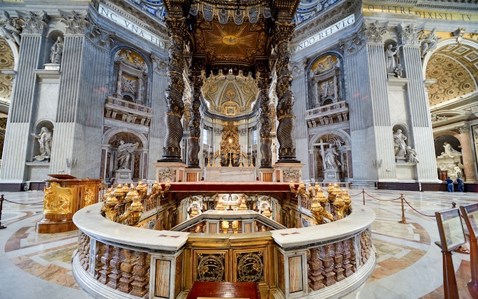 St. Peter's Basilica interior with ornate altar and spiral columns in Vatican City.