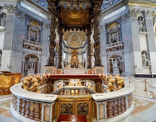 Papal altar inside St. Peter's Basilica, Vatican City, showcasing intricate architecture.