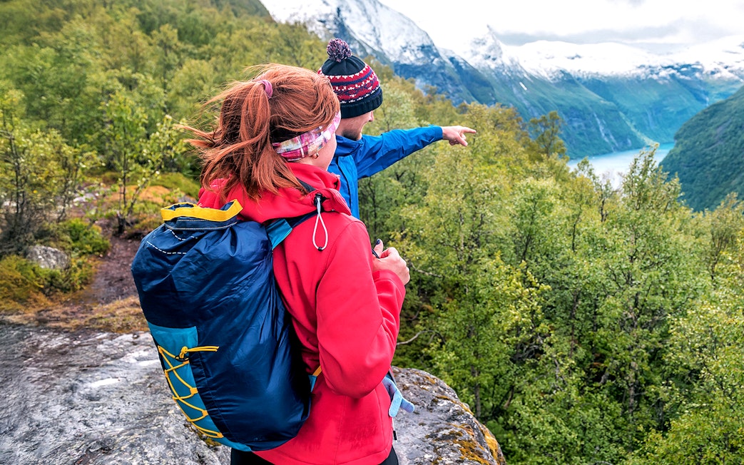 Guide pointing out Tromsø landscape, highlighting Sami culture tour.