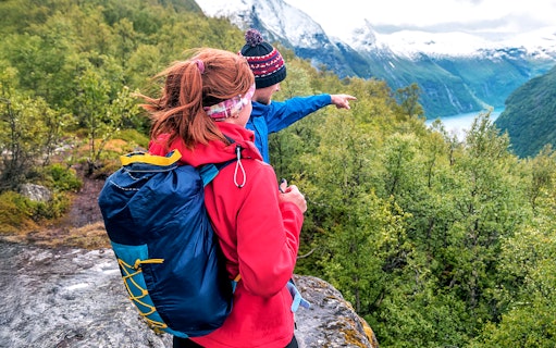 Guide pointing out Tromsø landscape, highlighting Sami culture tour.