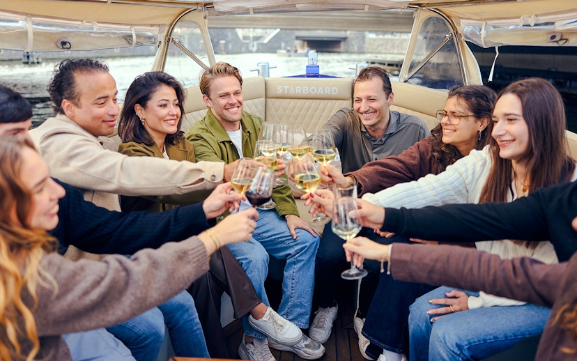 Guests toasting with wine on an evening candlelight cruise.