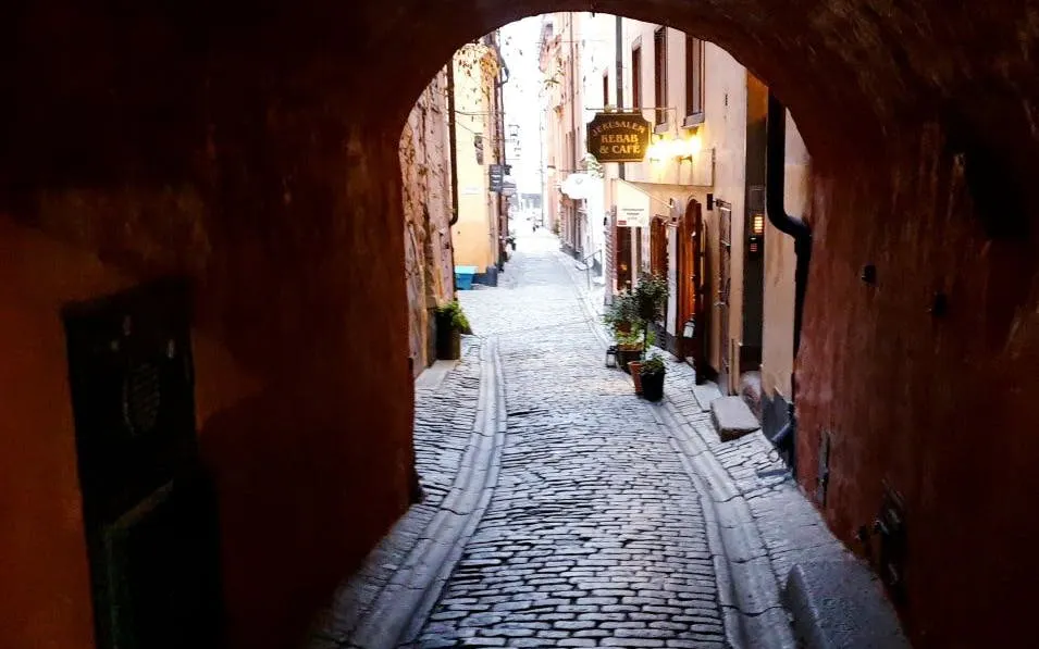 Cobblestone alley in Stockholm's Old Town for self-guided ghost exploration game.