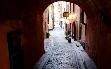 Cobblestone alley in Stockholm's Old Town for self-guided ghost exploration game.
