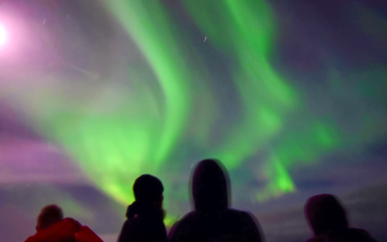 Guests viewing northern lights from a cruise ship deck.