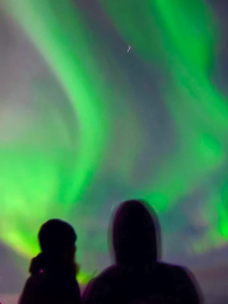 Guests viewing northern lights from a cruise ship deck.