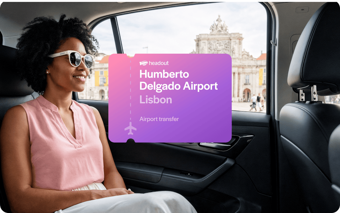 Private car transfer from Humberto Delgado Airport, Lisbon, with view of city landmark.