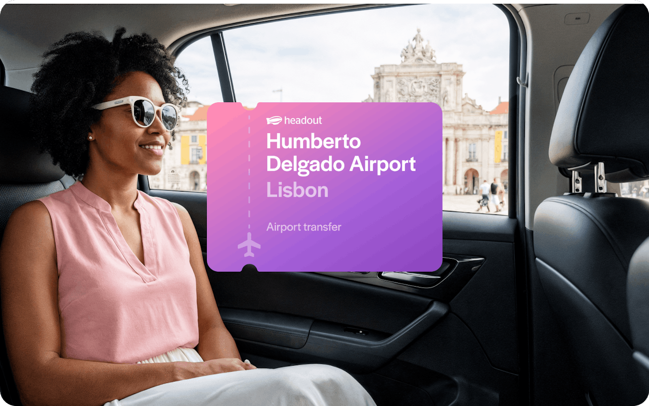 Private car transfer from Humberto Delgado Airport, Lisbon, with view of city landmark.