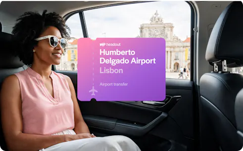 Private car transfer from Humberto Delgado Airport, Lisbon, with view of city landmark.