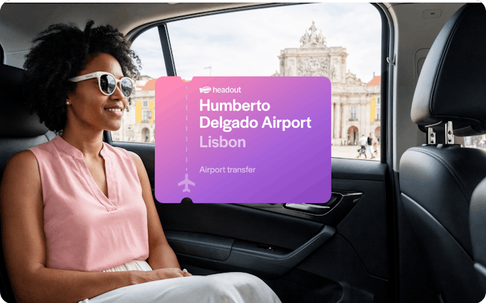 Private car transfer from Humberto Delgado Airport, Lisbon, with view of city landmark.