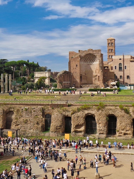 Crowds exploring ancient ruins and catacombs in Rome on a guided tour.