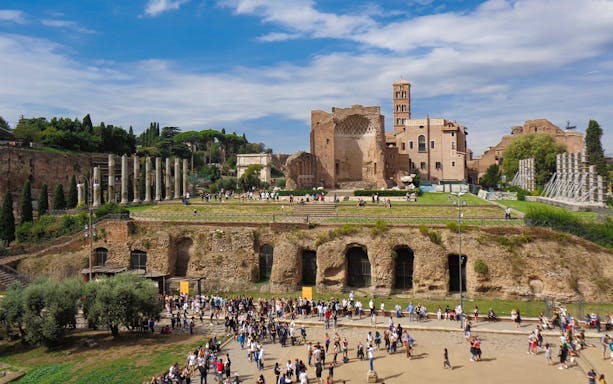Crowds exploring ancient ruins and catacombs in Rome on a guided tour.
