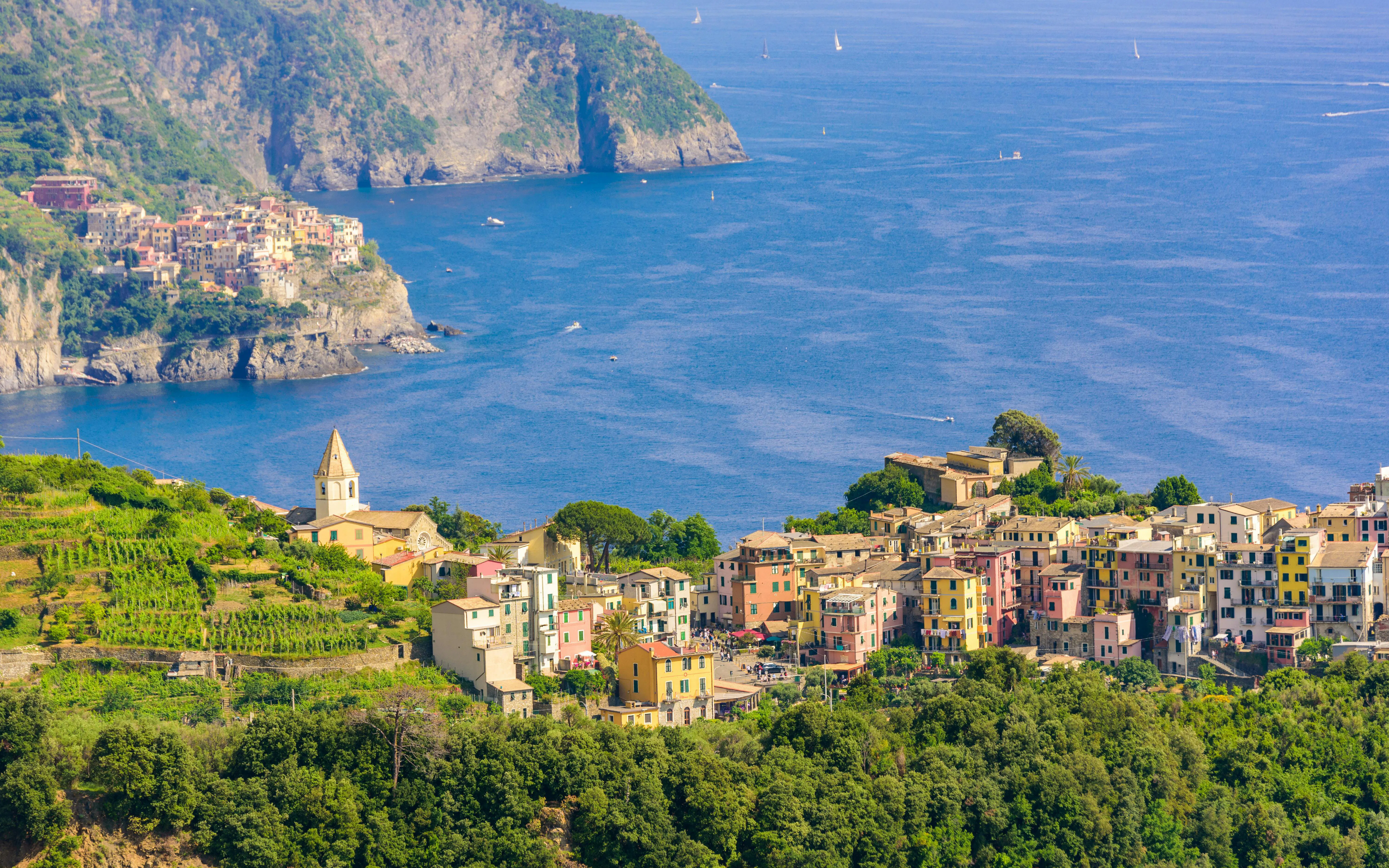 Corniglia village in Cinque Terre National Park with Manarola in the background, Liguria, Italy.