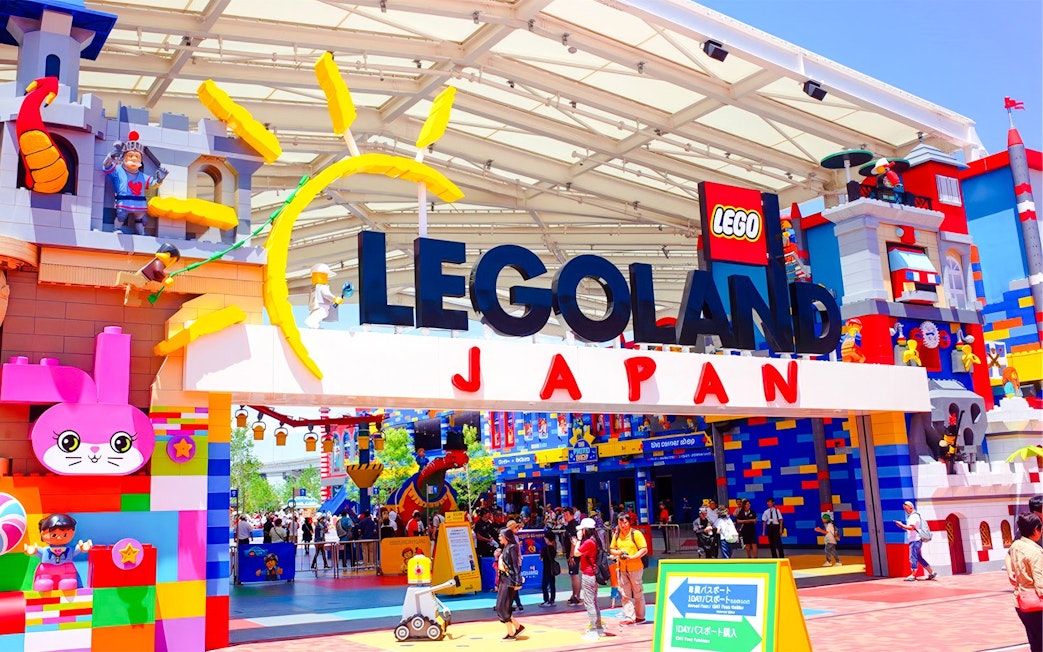Entrance to Legoland Japan with colorful Lego structures and visitors exploring the theme park.