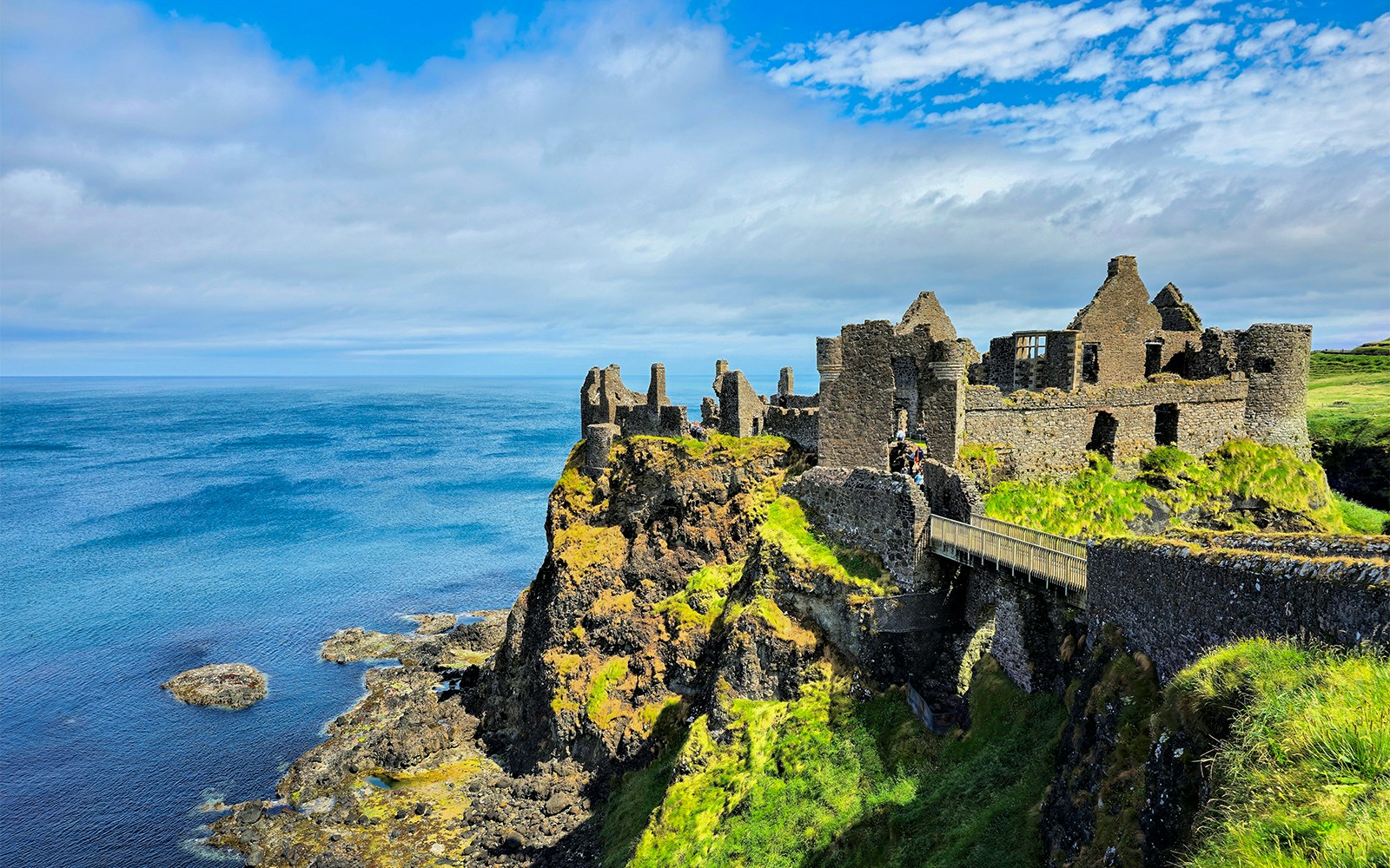 Dunluce Castle ruins on a cliff overlooking the North Atlantic Ocean in Northern Ireland.