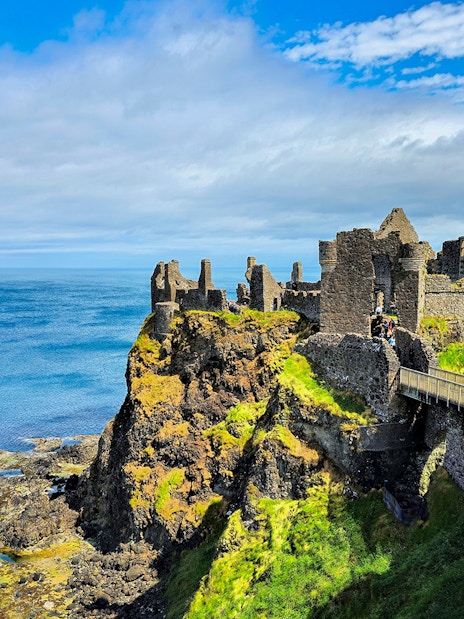 Dunluce Castle ruins on a cliff overlooking the North Atlantic Ocean in Northern Ireland.