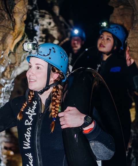 Participants exploring cave during Black Water Rafting in Waitomo.