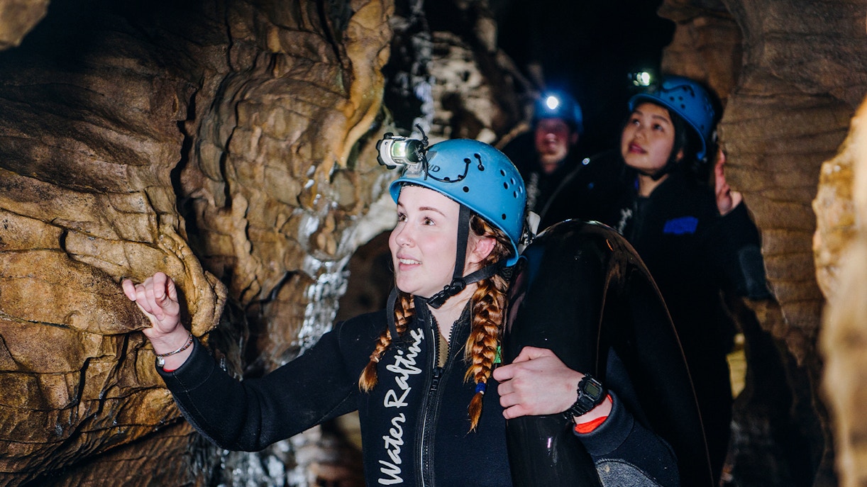 Participants exploring cave during Black Water Rafting in Waitomo.