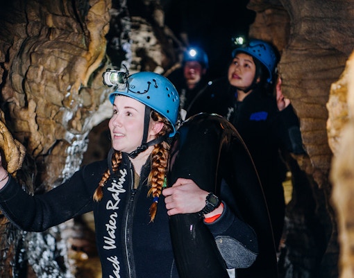 Participants exploring cave during Black Water Rafting in Waitomo.