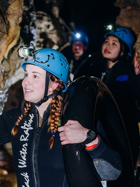 Participants exploring cave during Black Water Rafting in Waitomo.