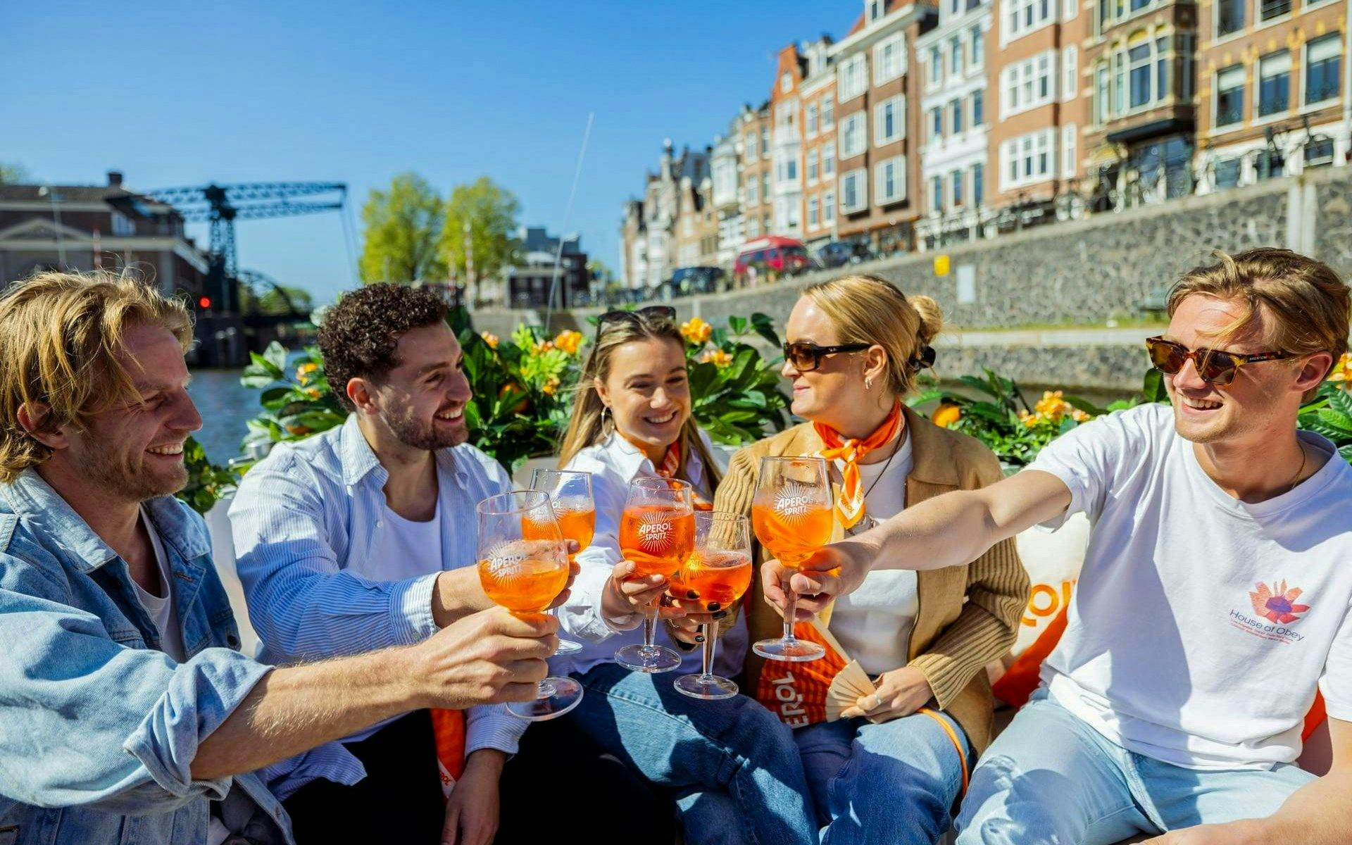 Guests enjoying Aperol Spritz on a canal cruise in Amsterdam.