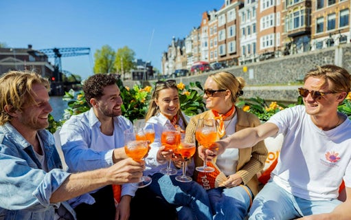 Guests enjoying Aperol Spritz on a canal cruise in Amsterdam.
