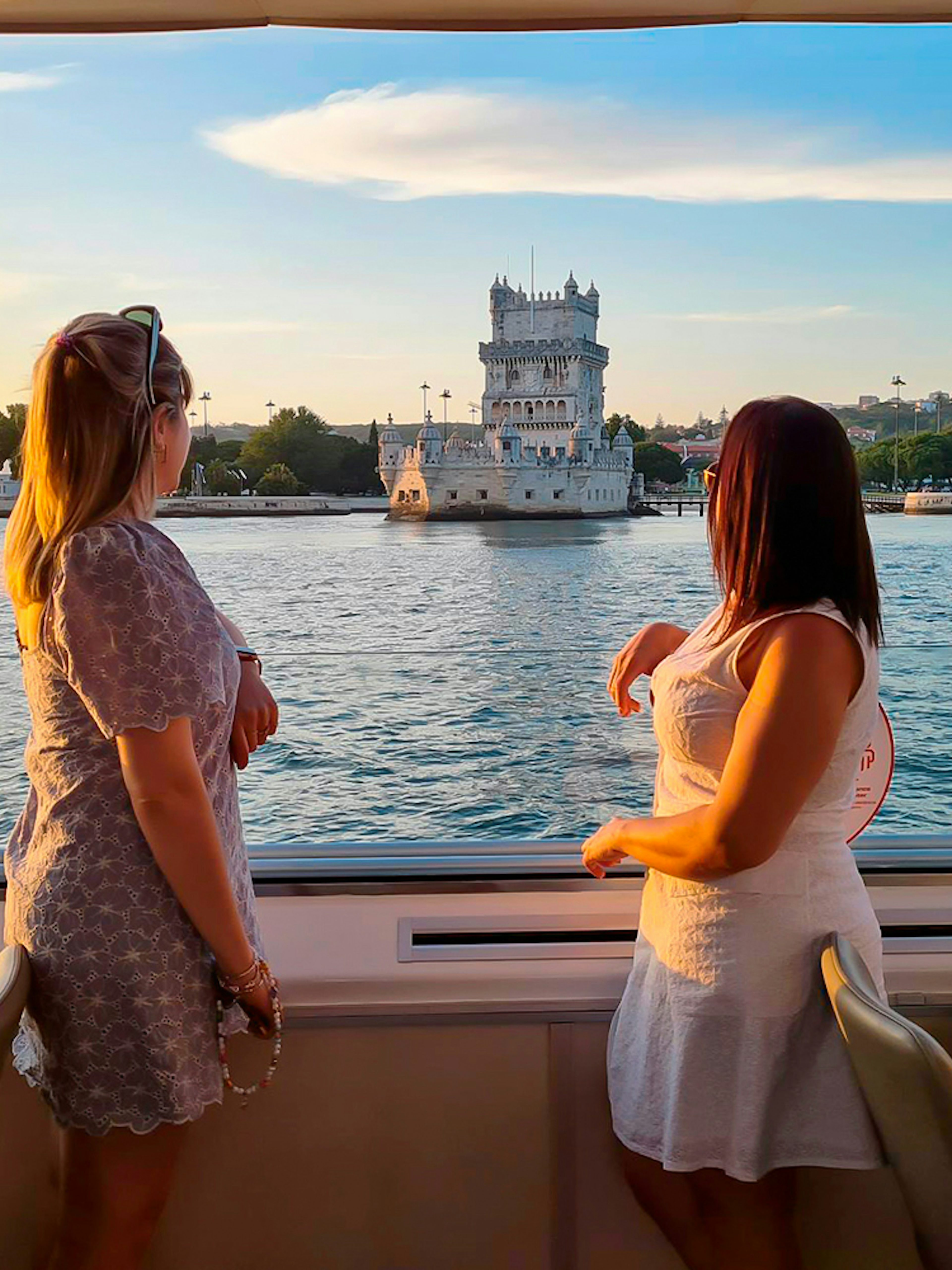 Sunset view of Belém Tower from a cruise on the Tagus River in Lisbon.