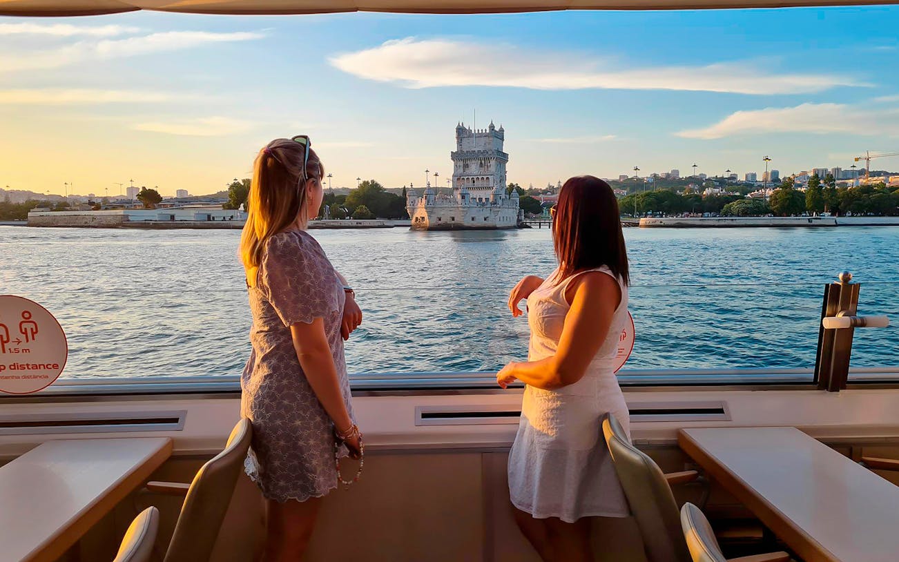 Sunset view of Belém Tower from a cruise on the Tagus River in Lisbon.