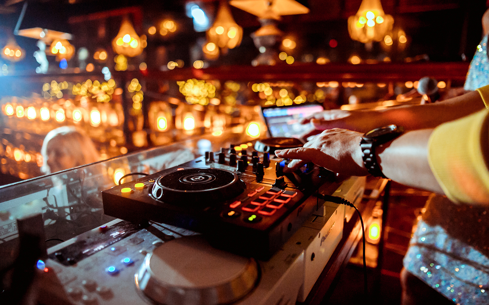 DJ performing at a vibrant event in a lively atmosphere.