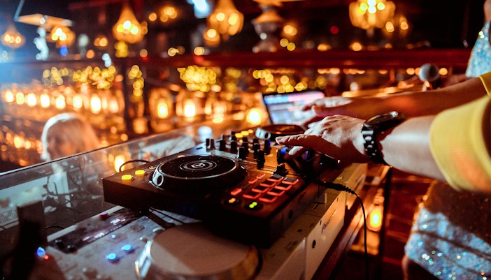 DJ performing at a vibrant event in a lively atmosphere.