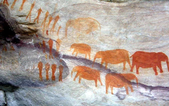 Drakensberg rock art depicting human figures and elephants, South Africa.