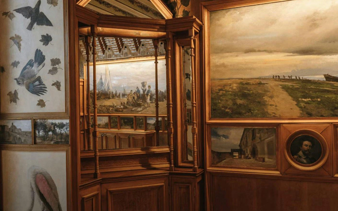 Casa Vicens main floor with detailed wall paintings and wooden architectural elements.