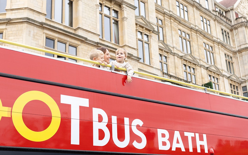 Mother and children enjoying view from Toot bus rooftop in Bath.