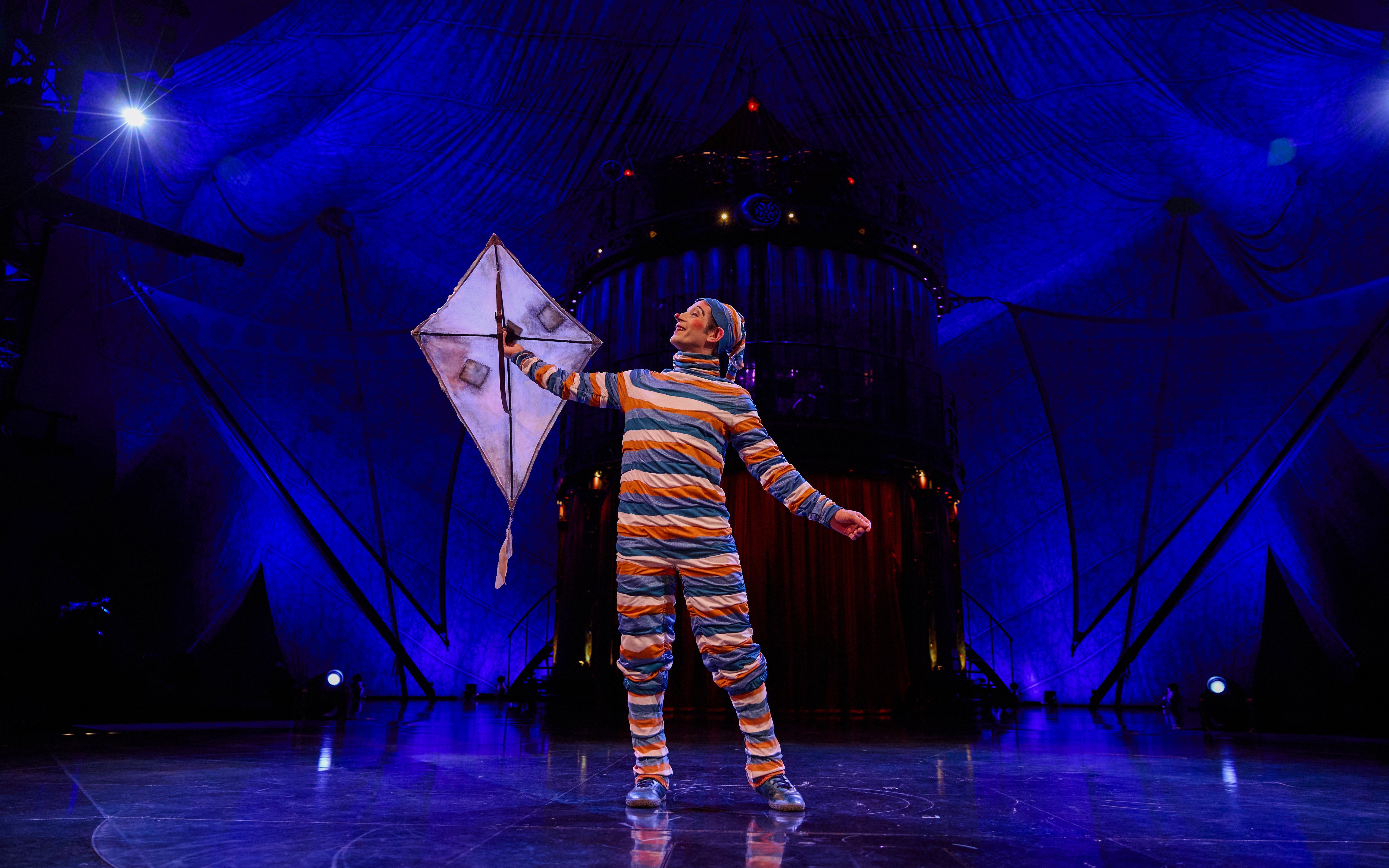 Performer with kite on stage during Kooza show in Brisbane.