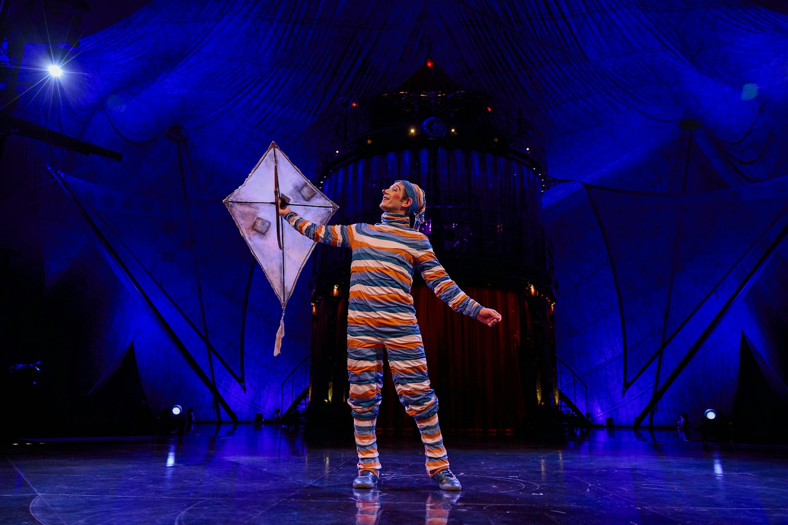 Performer with kite on stage during Kooza show in Brisbane.