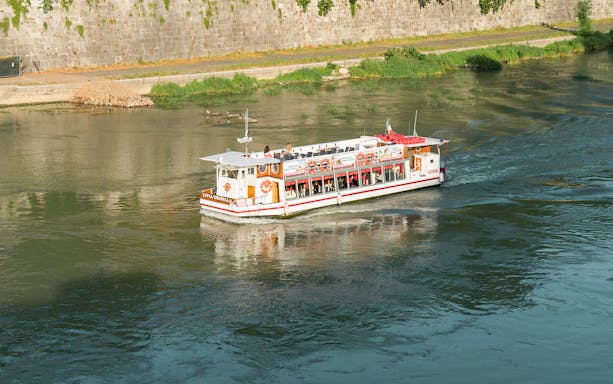 Hop-on hop-off river cruise boat on the Tiber River in Rome.