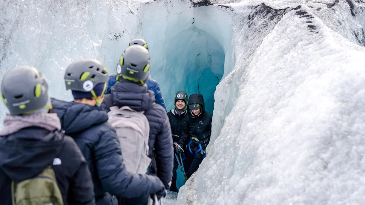 Guests exploring an ice cave on Sólheimajökull glacier in Iceland.
