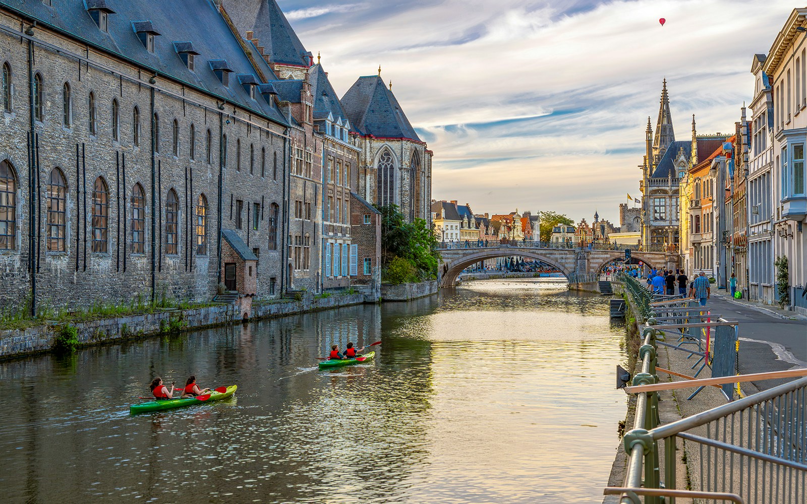 Kayakers on the Leie River in medieval Ghent, Belgium, at twilight.