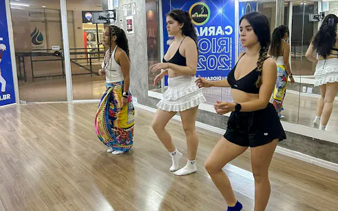 Participants learning samba dance in a Rio de Janeiro studio during the Brazilian Rhythms Experience.
